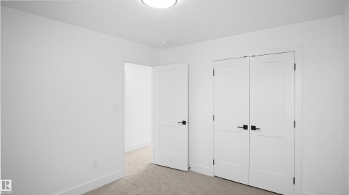 Unfurnished bedroom with light colored carpet and a closet - 711 31 Avenue, Edmonton, AB - Indoor Photo Showing Other Room
