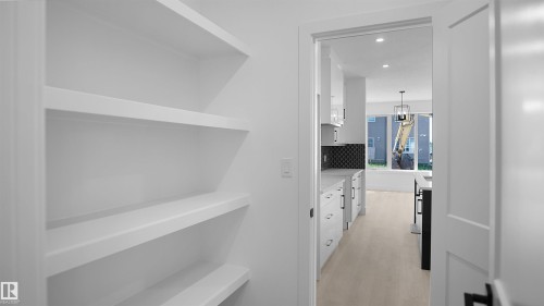 Hallway with recessed lighting and light wood finished floors - 711 31 Avenue, Edmonton, AB - Indoor