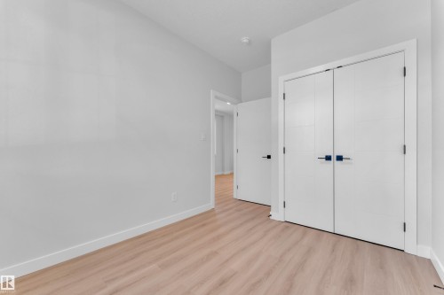 Unfurnished bedroom with light wood-style flooring and a closet - 9531/ 9533 115 Ave, Edmonton, AB - Indoor Photo Showing Other Room