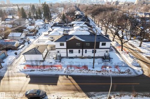 Snowy aerial view featuring a residential view and a city view - 9531/ 9533 115 Ave, Edmonton, AB - Outdoor With View