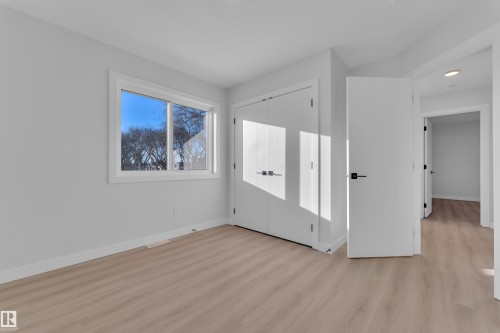 Unfurnished bedroom with light wood-type flooring and a closet - 9531/ 9533 115 Ave, Edmonton, AB - Indoor Photo Showing Other Room