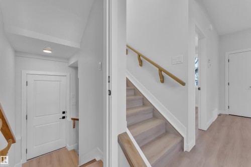 Entrance foyer with stairs and light wood-style flooring - 9531/ 9533 115 Ave, Edmonton, AB - Indoor Photo Showing Other Room