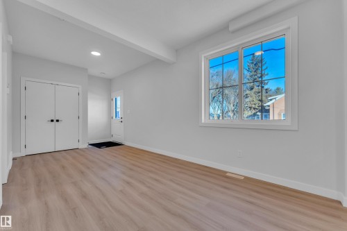 Unfurnished bedroom featuring light wood-style flooring, beamed ceiling, a closet, and recessed lighting - 9531/ 9533 115 Ave, Edmonton, AB - Indoor Photo Showing Other Room