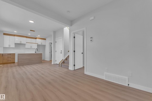 Unfurnished living room featuring light wood-style flooring and recessed lighting - 9531/ 9533 115 Ave, Edmonton, AB - Indoor