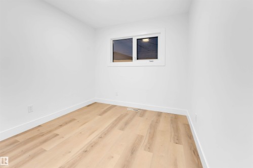 Spare room with baseboards and light wood finished floors - 7303 130 Avenue, Edmonton, AB - Indoor Photo Showing Other Room