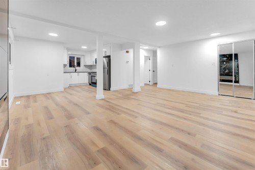 Unfurnished living room featuring light wood-style flooring and recessed lighting - 7303 130 Avenue, Edmonton, AB - Indoor