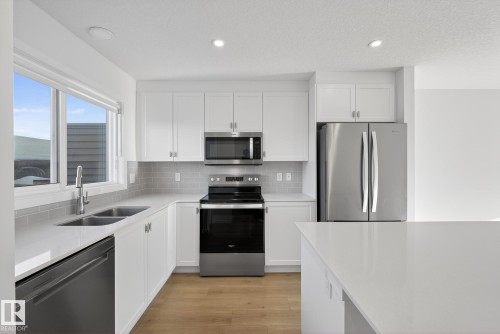 2416 Trumpeter Way, Edmonton, AB - Indoor Photo Showing Kitchen With Double Sink