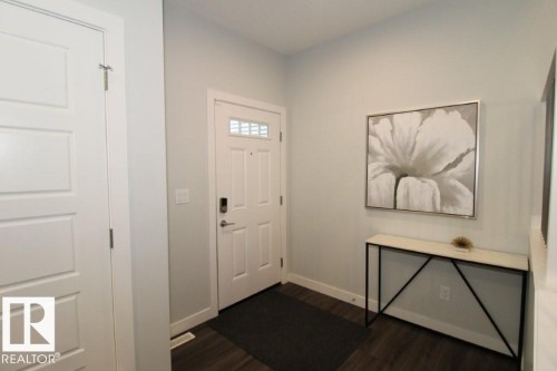 Foyer entrance featuring dark wood finished floors - 22140 81 Avenue, Edmonton, AB - Indoor Photo Showing Other Room