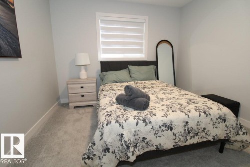 Bedroom featuring light carpet and baseboards - 22140 81 Avenue, Edmonton, AB - Indoor Photo Showing Bedroom