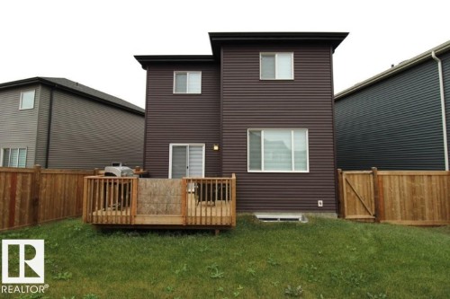 Rear view of property with a wooden deck, a fenced backyard, and a gate - 22140 81 Avenue, Edmonton, AB - Outdoor With Exterior