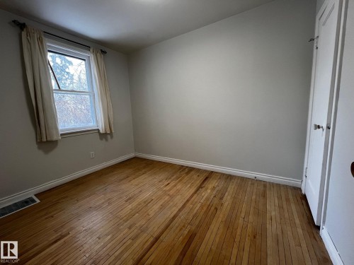 Unfurnished bedroom featuring light wood-style floors - 10830 68 Avenue, Edmonton, AB - Indoor Photo Showing Other Room