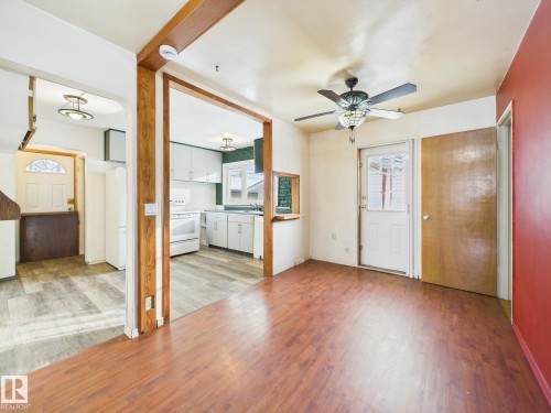 Unfurnished living room featuring light wood-type flooring and a ceiling fan - 13523 124B Avenue, Edmonton, AB - Indoor
