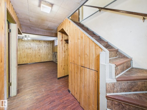 Stairs with wood finished floors and wood walls - 13523 124B Avenue, Edmonton, AB - Indoor Photo Showing Other Room