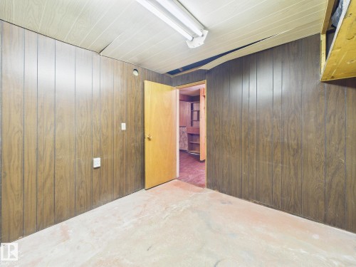 Empty room featuring wooden walls and concrete floors - 13523 124B Avenue, Edmonton, AB - Indoor Photo Showing Other Room