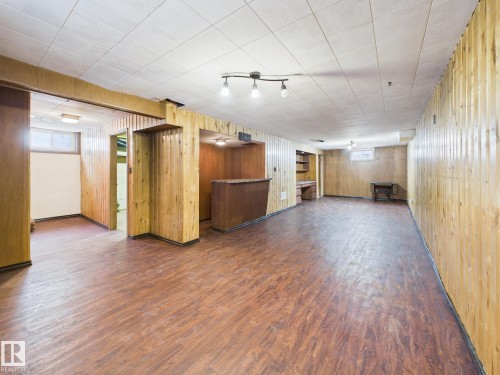 Below grade area with wood finished floors, healthy amount of natural light, and wooden walls - 13523 124B Avenue, Edmonton, AB - Indoor