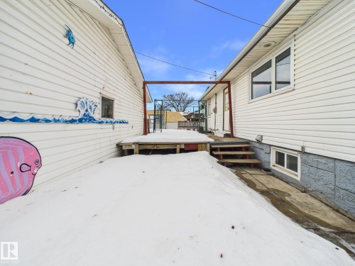 View of side of property featuring a deck - 13523 124B Avenue, Edmonton, AB - Outdoor With Exterior