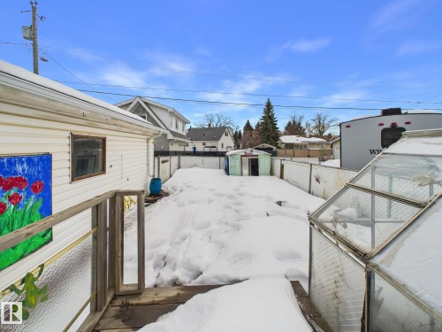Fenced backyard with an outdoor structure and a residential view - 13523 124B Avenue, Edmonton, AB - Outdoor With Exterior
