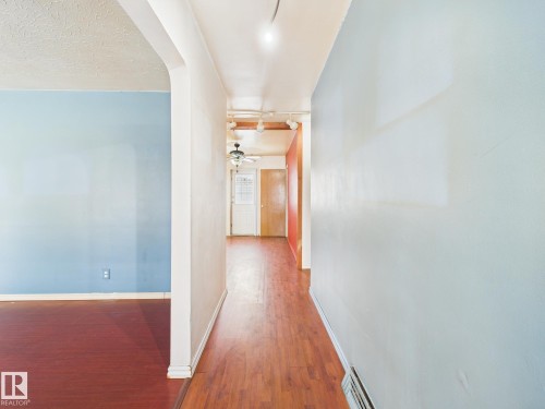 Corridor featuring wood finished floors and baseboards - 13523 124B Avenue, Edmonton, AB - Indoor Photo Showing Other Room