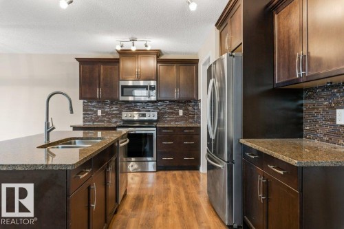 7803 173 Avenue, Edmonton, AB - Indoor Photo Showing Kitchen With Stainless Steel Kitchen With Double Sink With Upgraded Kitchen