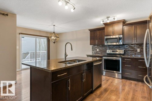 7803 173 Avenue, Edmonton, AB - Indoor Photo Showing Kitchen With Stainless Steel Kitchen With Double Sink With Upgraded Kitchen