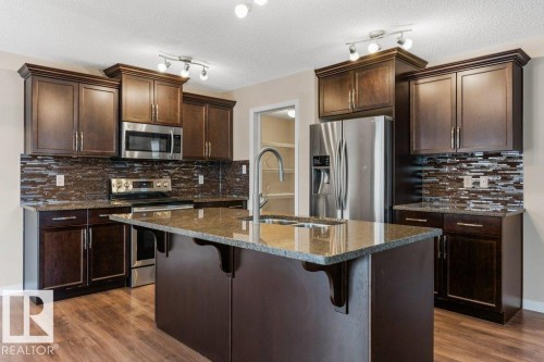 7803 173 Avenue, Edmonton, AB - Indoor Photo Showing Kitchen With Stainless Steel Kitchen With Double Sink With Upgraded Kitchen