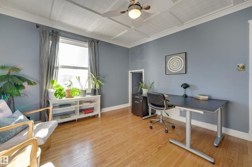 Office space featuring light wood-style floors, coffered ceiling, ceiling fan, and ornamental molding - 10911 66 Avenue, Edmonton, AB - Indoor Photo Showing Office