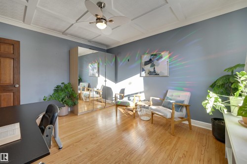 Office with coffered ceiling, a ceiling fan, wood finished floors, and crown molding - 10911 66 Avenue, Edmonton, AB - Indoor