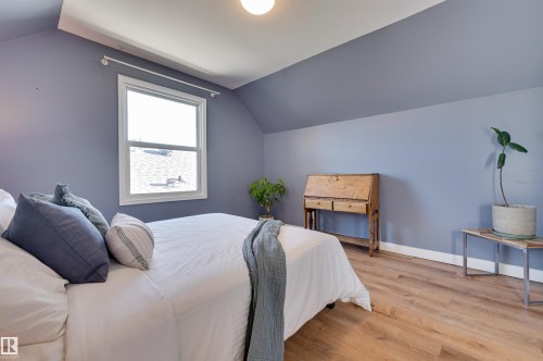Bedroom with light wood finished floors and vaulted ceiling - 10911 66 Avenue, Edmonton, AB - Indoor Photo Showing Bedroom