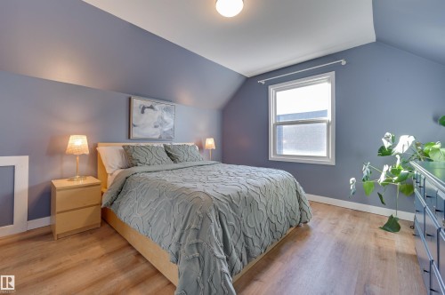 Bedroom featuring baseboards and light wood finished floors - 10911 66 Avenue, Edmonton, AB - Indoor Photo Showing Bedroom