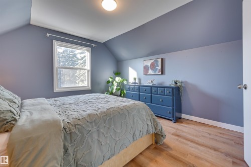 Bedroom with wood finished floors and baseboards - 10911 66 Avenue, Edmonton, AB - Indoor Photo Showing Bedroom