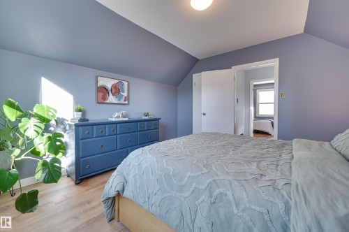 Bedroom with wood finished floors and lofted ceiling - 10911 66 Avenue, Edmonton, AB - Indoor Photo Showing Bedroom