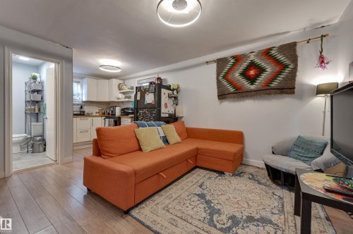 Living area with light wood-style floors - 10911 66 Avenue, Edmonton, AB - Indoor Photo Showing Living Room