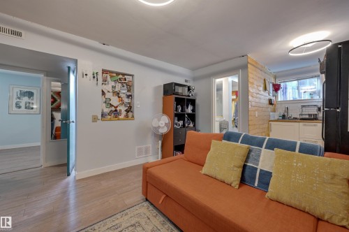 Living area with baseboards and light wood-style floors - 10911 66 Avenue, Edmonton, AB - Indoor Photo Showing Living Room