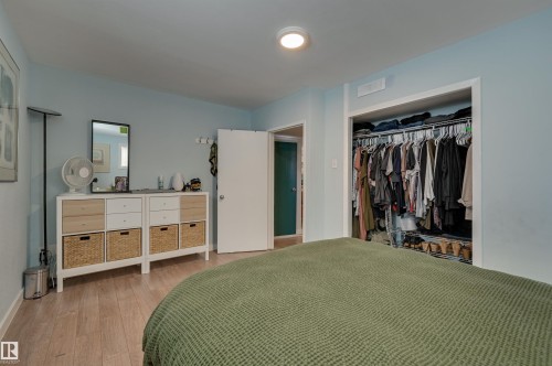 Bedroom with light wood finished floors and a closet - 10911 66 Avenue, Edmonton, AB - Indoor Photo Showing Bedroom