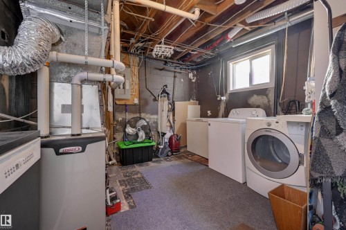 Laundry area with heating unit, washer and clothes dryer, and electric panel - 10911 66 Avenue, Edmonton, AB - Indoor Photo Showing Laundry Room