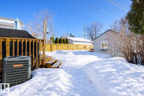 Snowy yard featuring a wooden deck - 10911 66 Avenue, Edmonton, AB - Outdoor