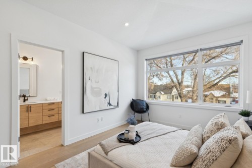 Bedroom featuring light wood-style floors, recessed lighting, and connected bathroom - 11016 132 Street, Edmonton, AB - Indoor