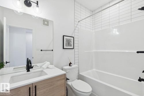 Bathroom featuring vanity and bathtub / shower combination - 11016 132 Street, Edmonton, AB - Indoor Photo Showing Bathroom