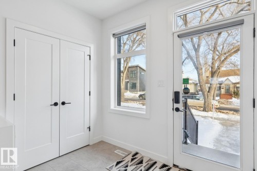 Doorway to outside with baseboards and tile patterned floors - 11016 132 Street, Edmonton, AB - Indoor Photo Showing Other Room