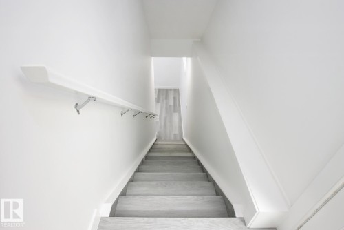 Staircase with wood finished floors - 11016 132 Street, Edmonton, AB - Indoor Photo Showing Other Room