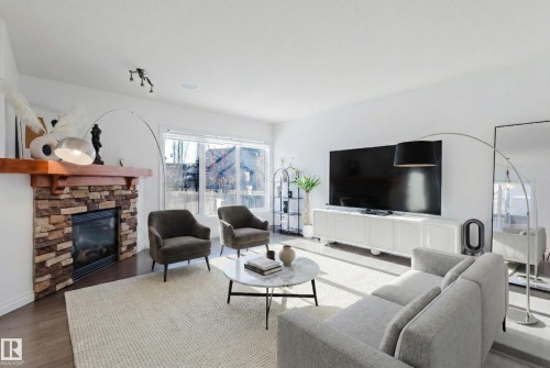 Living area with wood finished floors and a fireplace - 3547 Mclay Crescent, Edmonton, AB - Indoor Photo Showing Living Room With Fireplace