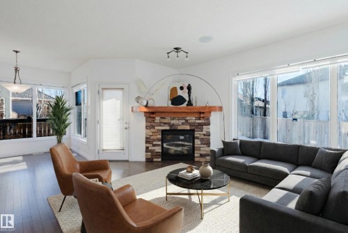 Living room featuring a fireplace and hardwood / wood-style flooring - 3547 Mclay Crescent, Edmonton, AB - Indoor Photo Showing Living Room With Fireplace