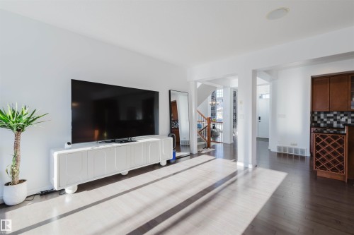 Living area featuring dark wood finished floors and stairs - 3547 Mclay Crescent, Edmonton, AB - Indoor Photo Showing Living Room