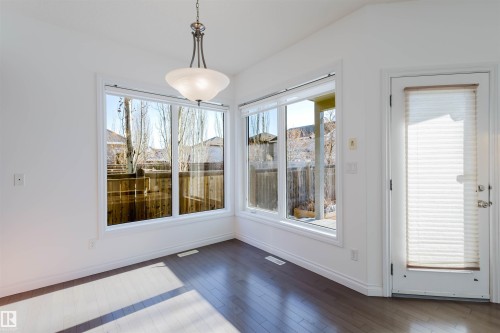 Unfurnished dining area with dark wood-style flooring and baseboards - 3547 Mclay Crescent, Edmonton, AB - Indoor Photo Showing Other Room