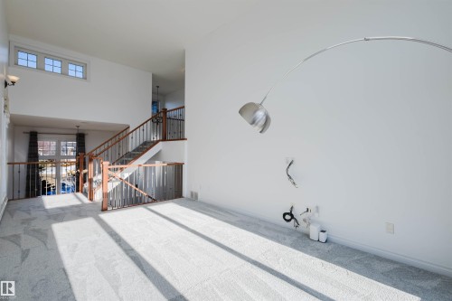 Unfurnished living room featuring a high ceiling and carpet floors - 3547 Mclay Crescent, Edmonton, AB -  Photo Showing Other Room