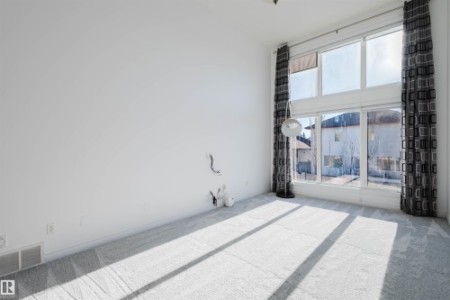 Unfurnished room with carpet floors and a high ceiling - 3547 Mclay Crescent, Edmonton, AB - 