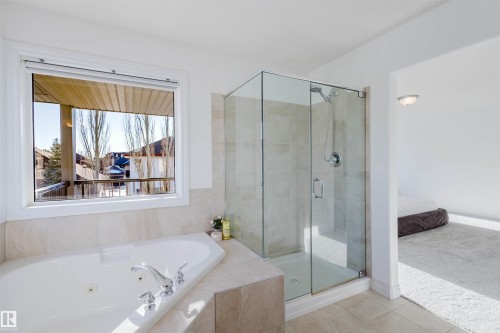 Bathroom with a tub with jets, a shower stall, tile patterned floors, and connected bathroom - 3547 Mclay Crescent, Edmonton, AB - Indoor Photo Showing Bathroom