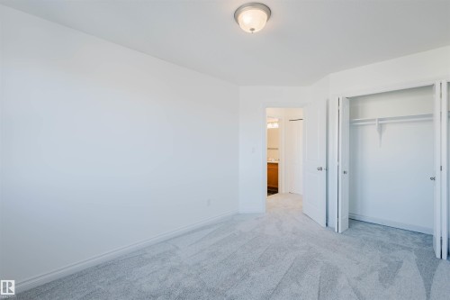 Unfurnished bedroom with carpet floors and a closet - 3547 Mclay Crescent, Edmonton, AB - Indoor Photo Showing Other Room