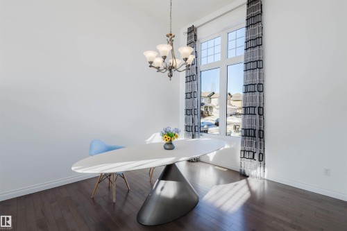 Dining room featuring dark wood-type flooring and hanging lights - 3547 Mclay Crescent, Edmonton, AB - Indoor Photo Showing Dining Room