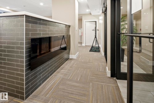 109 11080 Ellerslie Road, Edmonton, AB - Indoor Photo Showing Other Room With Fireplace